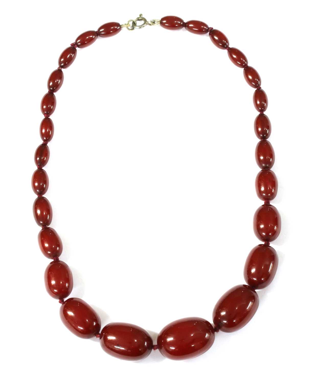 Lot 68 - A single row graduated oval cherry coloured Bakelite bead necklace