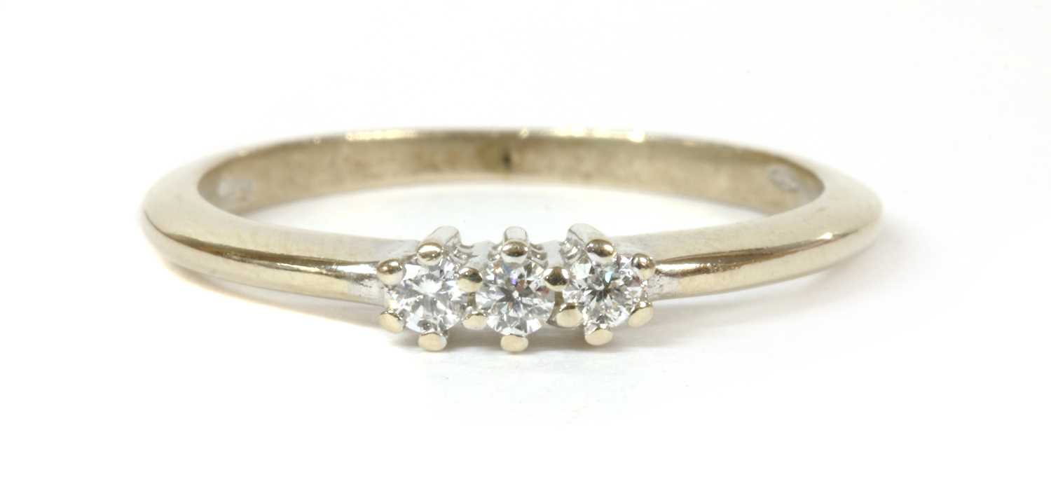 Lot 225 - A white gold three stone diamond ring