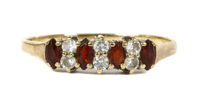 Lot 279 - A 9ct gold garnet and cubic zirconia ring