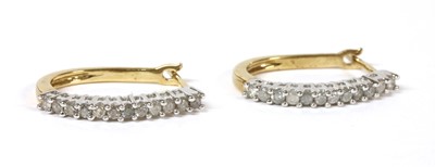 Lot 212 - A pair of 9ct gold diamond oval hoop earrings