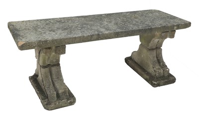 Lot 992 - A weathered stone garden bench