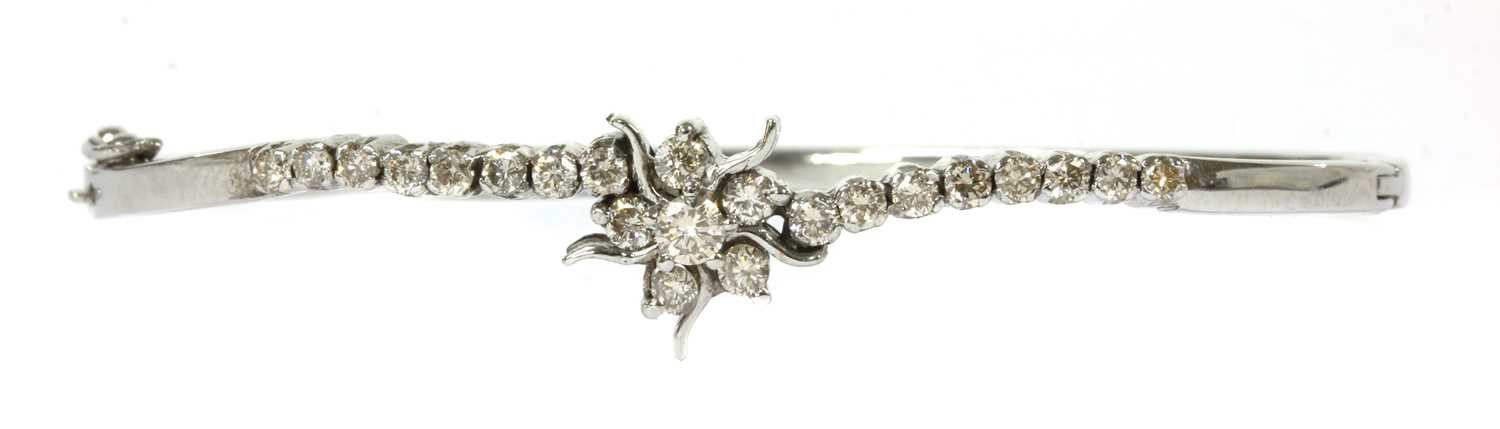 Lot 173 - A white gold diamond hinged bangle