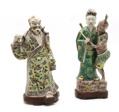 Lot 230 - A 19th century Chinese porcelain figure group depicting an elder with tribesman beside