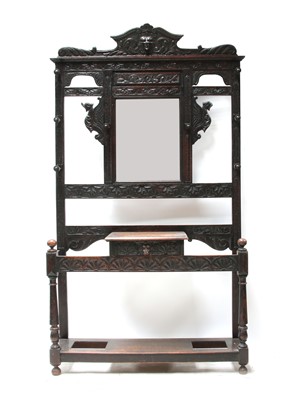 Lot 410 - An early 20th Century carved oak hallstand