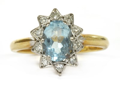 Lot 127 - A gold aquamarine and diamond cluster ring