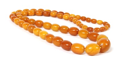 Lot 209 - A continuous single row graduated olive-shaped butterscotch amber bead necklace