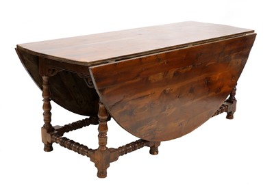 Lot 375 - A solid yew wood gateleg table