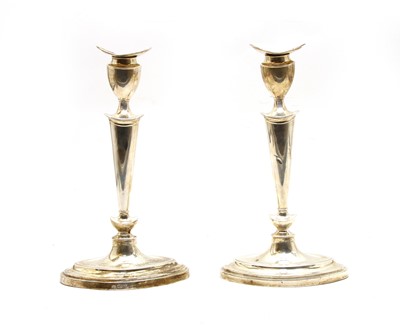 Lot 1 - A pair of George V silver candlesticks
