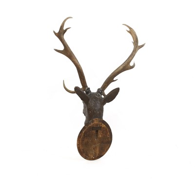 Lot 273 - A Black Forest carved wood stag's head, with mounted antlers