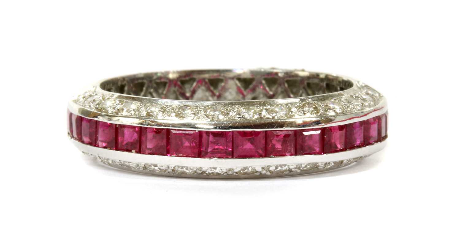 Lot 47 - A white gold ruby and diamond half eternity ring