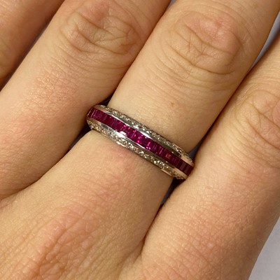 Lot 47 - A white gold ruby and diamond half eternity ring