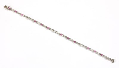 Lot 215 - An 18ct white gold pink sapphire and diamond bracelet
