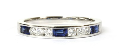 Lot 103 - A white gold sapphire and diamond half eternity ring