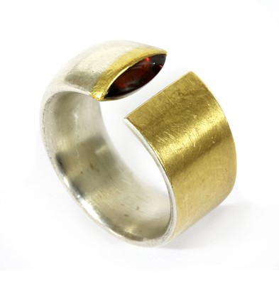 Lot 236 - A silver and gold garnet torque ring by Manu Schmuck