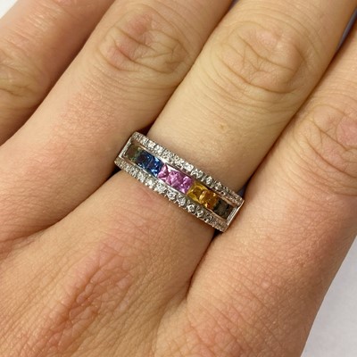 Lot 218 - An 18ct white gold rainbow sapphire and diamond ring