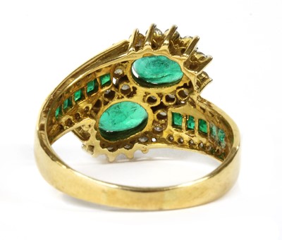 Lot 161 - An 18ct gold emerald and diamond cluster crossover ring