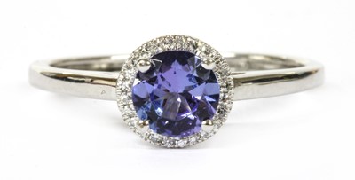 Lot 139 - A white gold tanzanite and diamond halo cluster ring
