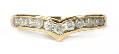 Lot 63 - A gold diamond wishbone half eternity ring