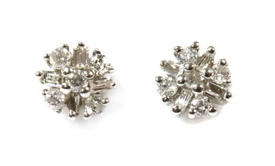 Lot 340 - A pair of white gold diamond cluster earrings