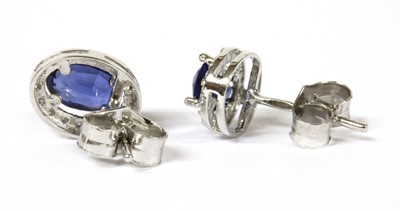 Lot 106 - A pair of white gold sapphire and diamond cluster earrings