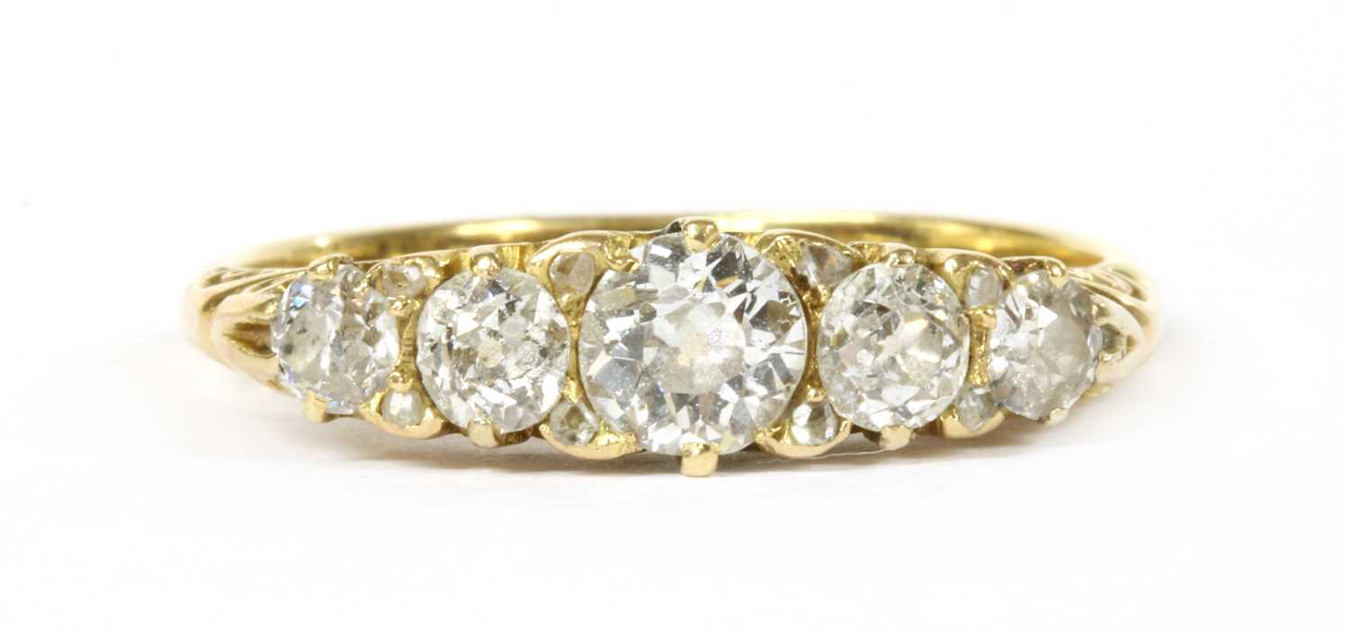 Lot 8 - A gold five stone graduated diamond carved head-style ring