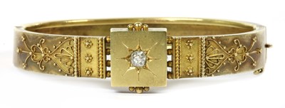 Lot 290 - A Victorian Etruscan Revival gold diamond hinged bangle, c.1870