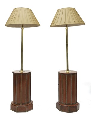 Lot 860 - A pair of leather and brass-nailed drum base lamp standards
