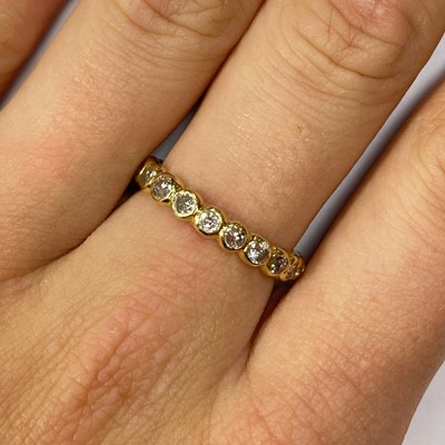 Lot 9 - A gold diamond full eternity ring