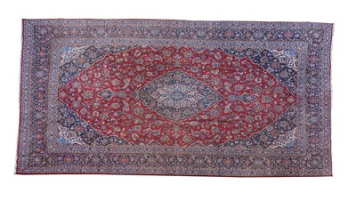 Lot 931 - A large Persian Kashan carpet