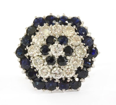 Lot 111 - A white gold diamond and sapphire target cluster ring