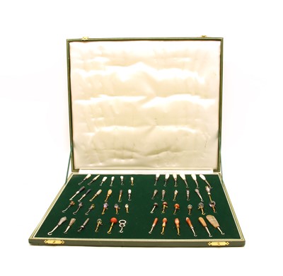 Lot 442 - A cased collection of button hooks with various handles