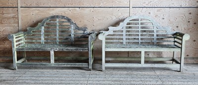 Lot 991 - A pair of Lutyens-style weathered teak garden benches