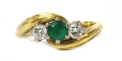 Lot 356 - An 18ct gold three stone emerald and diamond ring