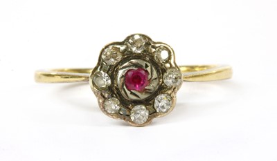 Lot 325 - A gold ruby and diamond cluster ring