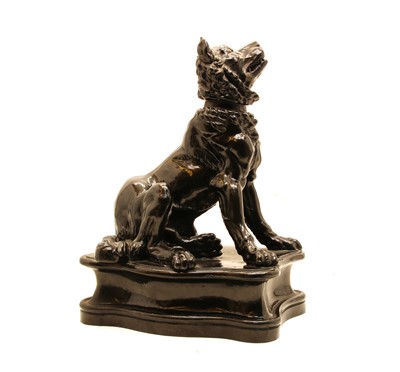 Lot 132 - A black glazed stoneware figure of a dog