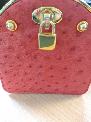 Lot 103 - An Asprey deep coral coloured ostrich leather coin purse