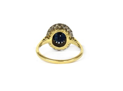 Lot 106 - An 18ct gold sapphire and diamond cluster ring