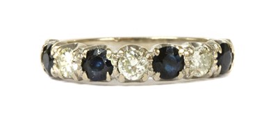 Lot 373 - An 18ct white gold sapphire and diamond half eternity ring
