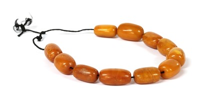 Lot 42 - Eleven butterscotch amber beads