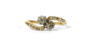 Lot 148 - A gold two stone diamond crossover ring