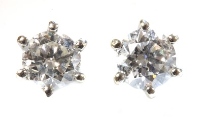 Lot 437 - A pair of white gold single stone diamond stud earrings