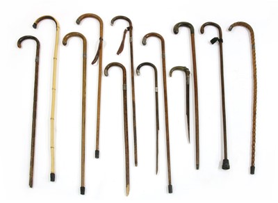 Lot 512 - A collection of seven Edwardian and later silver mounted walking sticks