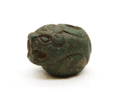 Lot 255 - A carved stone jaguar's head
