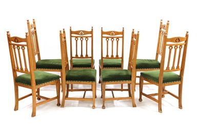Lot 51 - A set of eight Arts and Crafts oak dining chairs