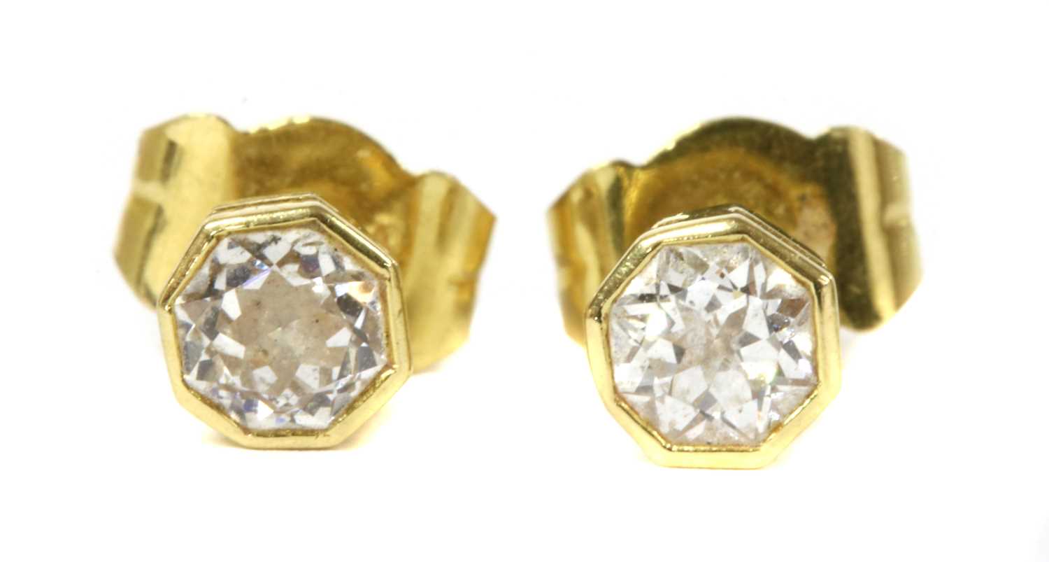 Lot 42 - A pair of 18ct gold single stone diamond stud earrings