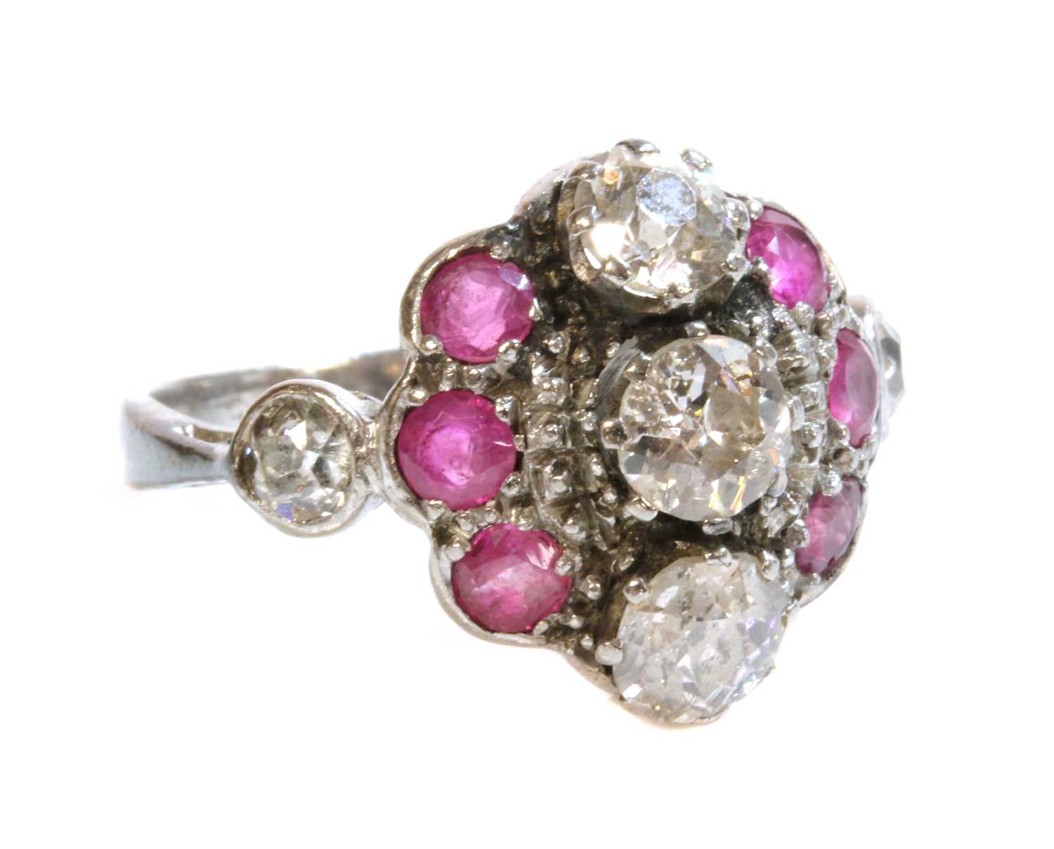 Lot 172 - A white gold diamond and ruby cluster ring, c.1935