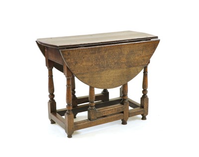 Lot 302 - A 17th century and later circular oak gate leg table