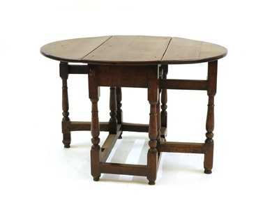 Lot 302 - A 17th century and later circular oak gate leg table