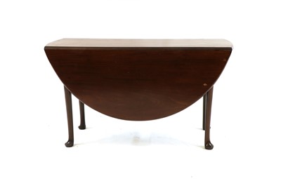 Lot 293 - A George lll style oval mahogany two flap table, with turned legs and pad feet