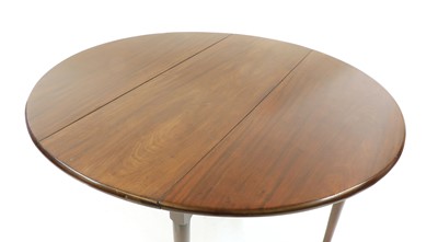Lot 293 - A George lll style oval mahogany two flap table, with turned legs and pad feet